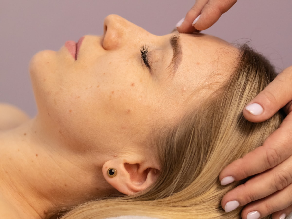 A client receiving a head and temple massage